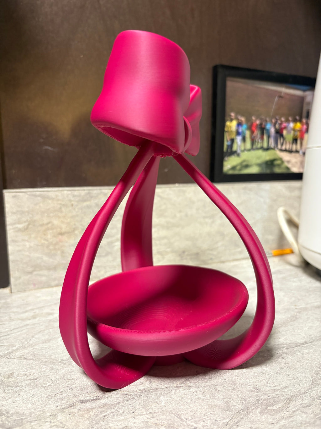 Side view of a pink bow jewellery dish; example colour.