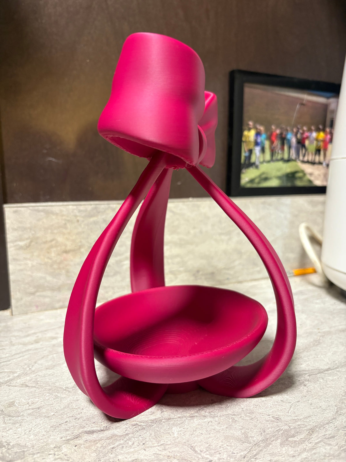 Side view of a pink bow jewellery dish; example colour.