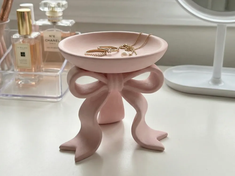 Sculptural Ribbon Bow Jewellery Tray — example colour. Includes: One finished printed item; display accessories excluded. Approximate dimensions (Width × Depth × Height): 1 supplied: 111.4 × 108.2 × 101.6 mm.