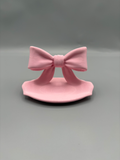 Ribbon Bow LED Tea Light Holder — example colour. Includes: One finished item supplied; display accessories are excluded. Approximate dimensions (Width × Depth × Height): 1 supplied: 101.6 × 65.3 × 64 mm.