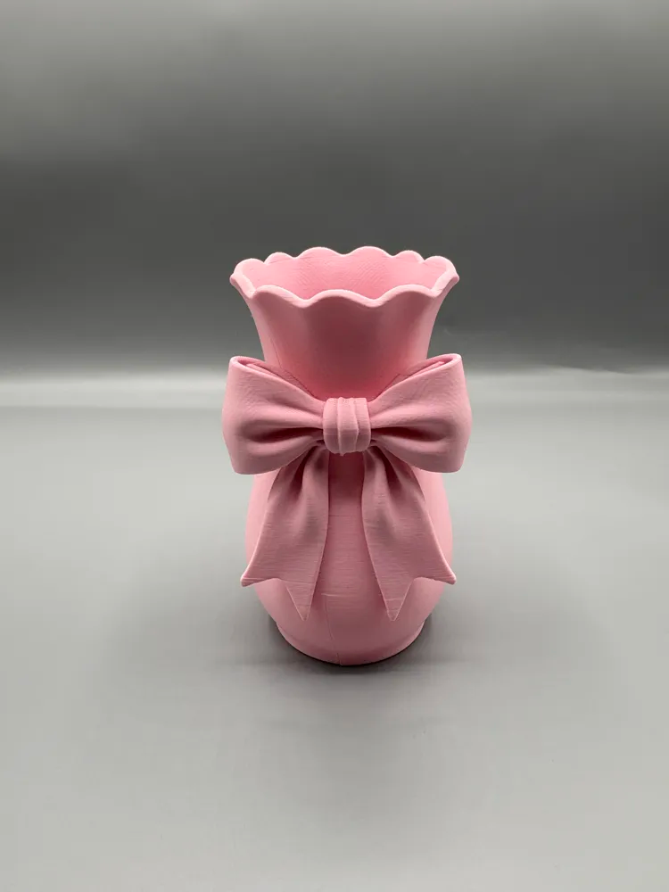 Sculptural Ribbon Bow Decorative Vase — example colour. Includes: One finished item supplied; display accessories are excluded. Approximate dimensions (Width × Depth × Height): 1 supplied: 91 × 88.9 × 165.1 mm.