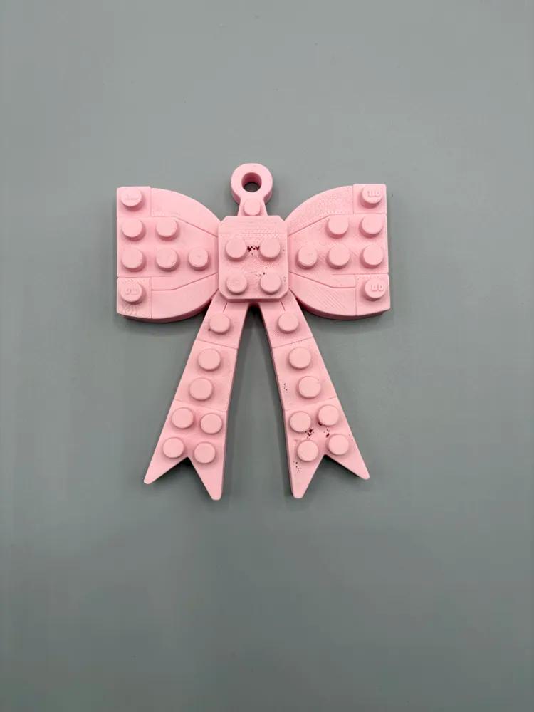 Stacked Brick-Style Bow Ornament — example colour. Includes: One finished item supplied; display accessories are excluded. Approximate dimensions (Width × Depth × Height): 1 supplied: 101.6 × 82.6 × 15.2 mm.
