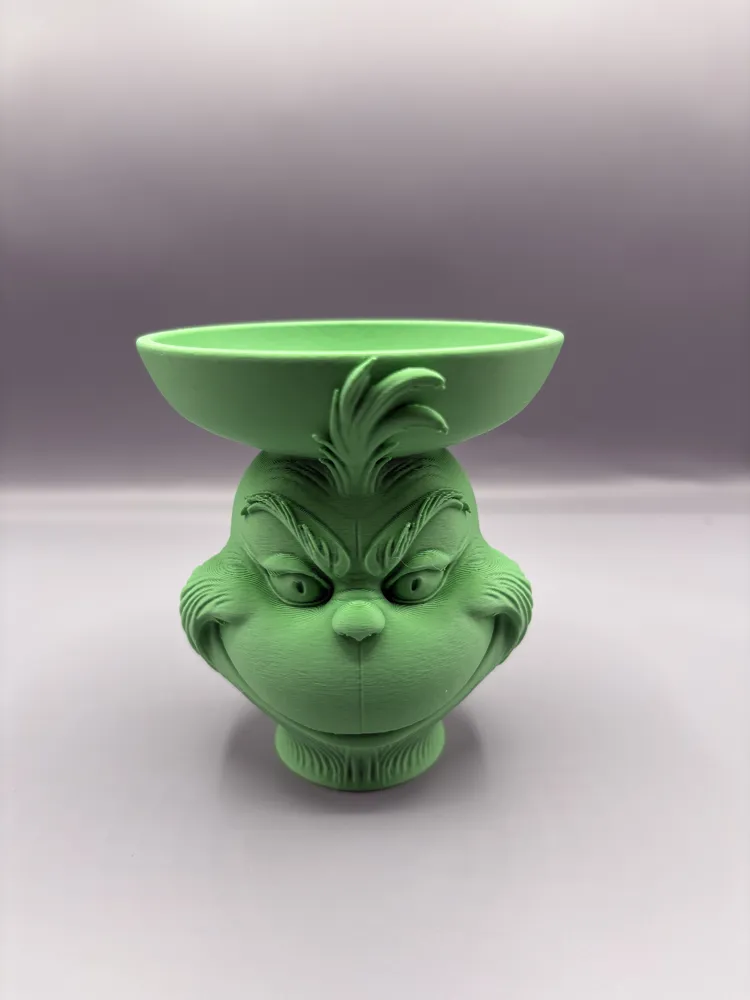 Grinning Holiday Creature Pedestal Bowl — example colour. Includes: One finished item supplied; display accessories are excluded. Approximate dimensions (Width × Depth × Height): 1 supplied: 104.5 × 103.3 × 114.3 mm.