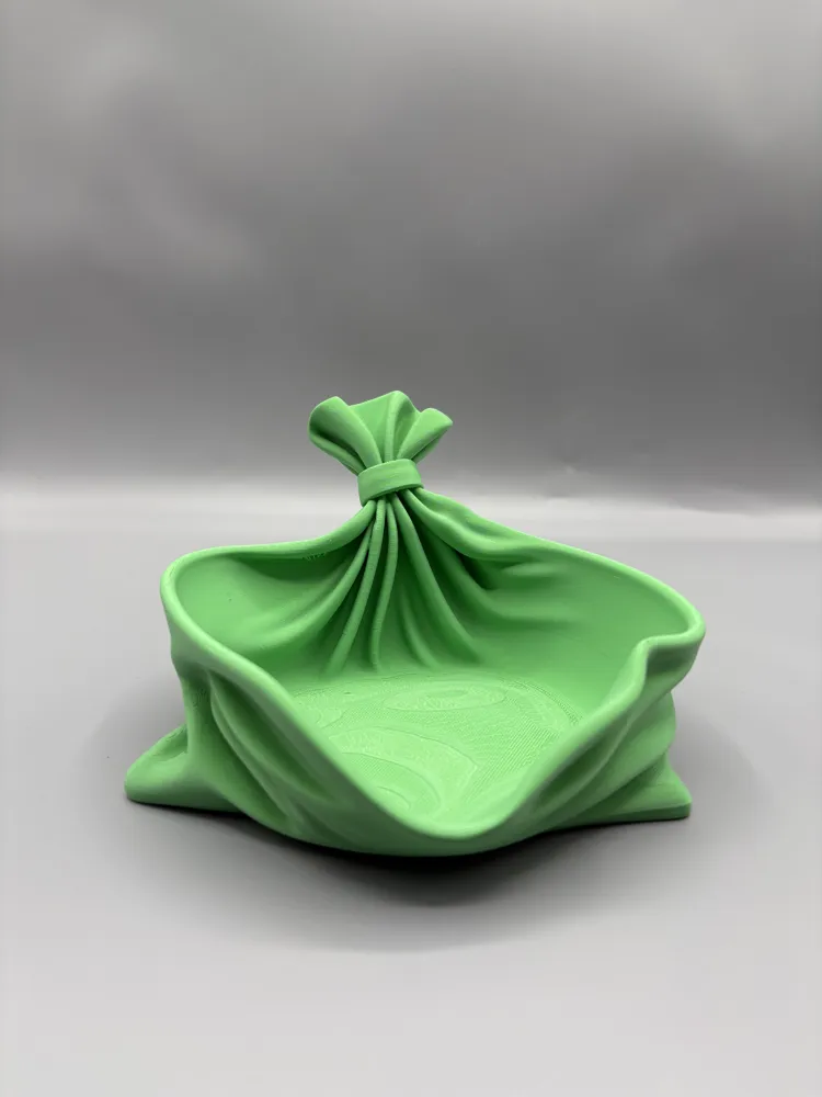Draped Fabric Knot Catchall Bowl — example colour. Includes: One finished item supplied; display accessories are excluded. Approximate dimensions (Width × Depth × Height): 1 supplied: 142.2 × 139.7 × 84.6 mm.