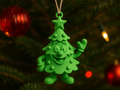 Cartoon Christmas Tree Hanging Ornament — example colour. Includes: One finished item supplied; display accessories are excluded. Approximate dimensions (Width × Depth × Height): 1 supplied: 101.6 × 73.5 × 25.4 mm.