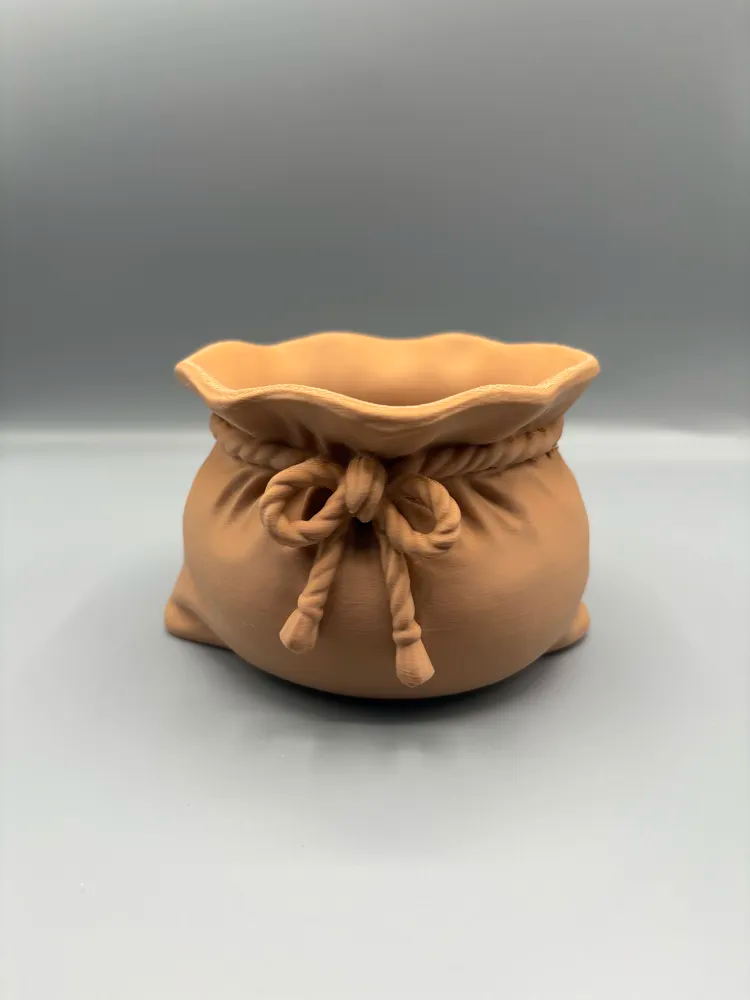 Santa Sack Wrapped-Treat Catchall Bowl — example colour. Includes: One finished item supplied; display accessories are excluded. Approximate dimensions (Width × Depth × Height): 1 supplied: 127 × 121.2 × 78.3 mm.