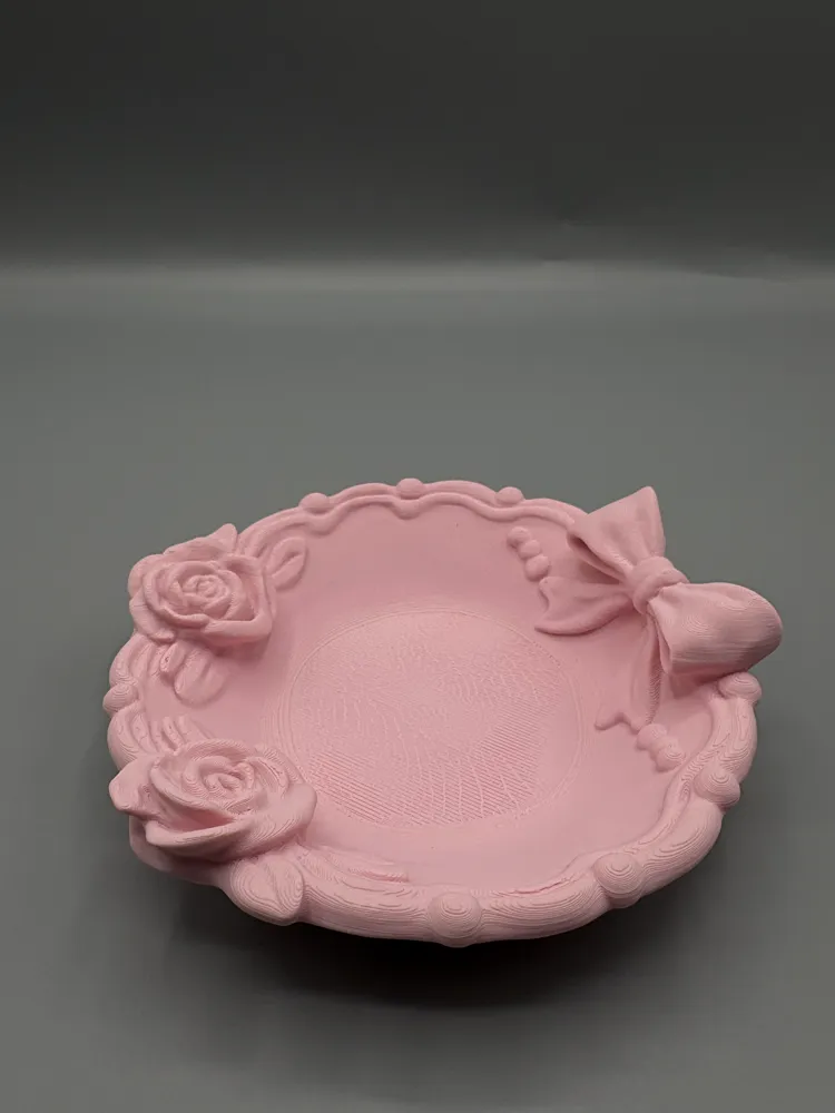 Ribbon Bow & Twin Rose Jewellery Dish — example colour. Includes: One finished item supplied; display accessories are excluded. Approximate dimensions (Width × Depth × Height): 1 supplied: 127.1 × 127 × 39.3 mm.