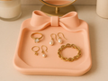 Bow Accent Jewellery Catchall Tray — example colour. Includes: One finished item supplied; display accessories are excluded. Approximate dimensions (Width × Depth × Height): 1 supplied: 152.4 × 128 × 32.8 mm.