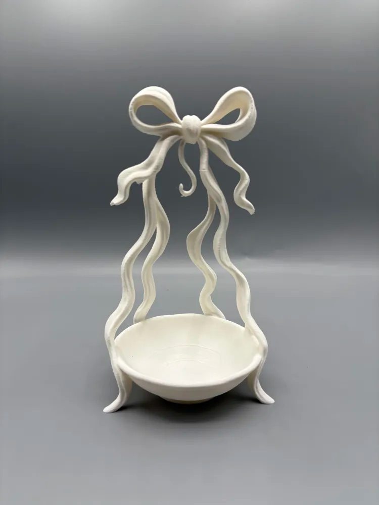 Ribbon-Leg Bow Jewellery Catchall — example colour. Includes: One finished item supplied; display accessories are excluded. Approximate dimensions (Width × Depth × Height): 1 supplied: 100.1 × 98.5 × 175.6 mm.
