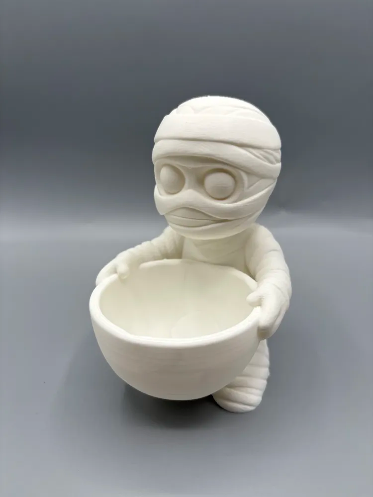 Mummy Halloween Wrapped-Treat Holder — example colour. Includes: One finished item supplied; display accessories are excluded. Approximate dimensions (Width × Depth × Height): 1 supplied: 148.9 × 121.5 × 177.8 mm.