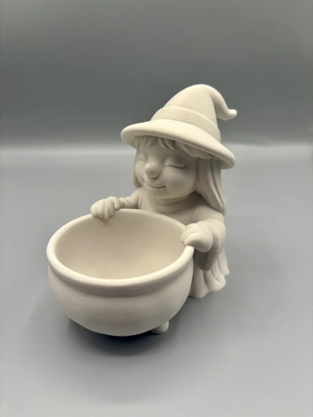 Smiling Witch & Cauldron Treat Bowl — example colour. Includes: One finished item supplied; display accessories are excluded. Approximate dimensions (Width × Depth × Height): 1 supplied: 146.9 × 90.4 × 127 mm.