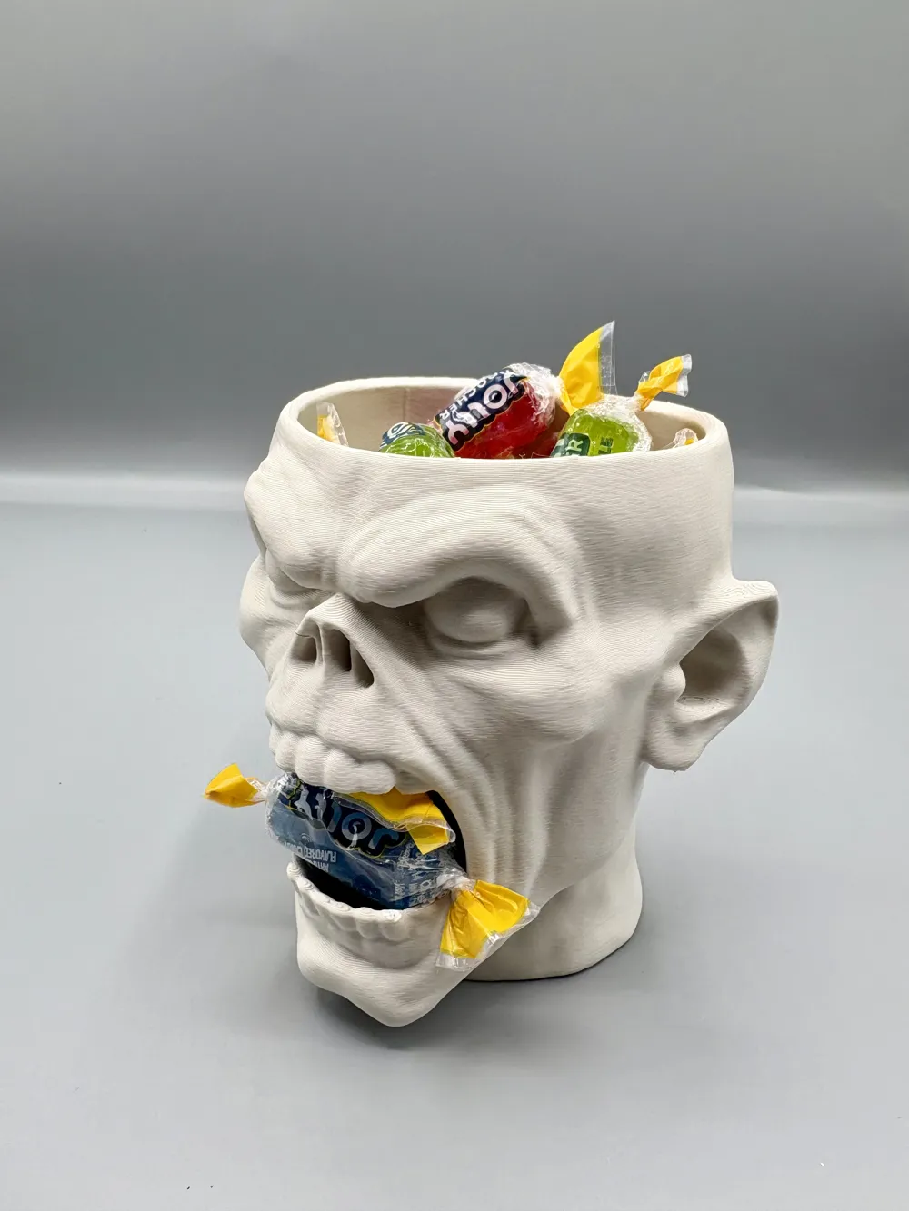 Open-Mouth Skull Halloween Treat Bowl — example colour. Includes: One finished item supplied; display accessories are excluded. Approximate dimensions (Width × Depth × Height): 1 supplied: 155.3 × 135.9 × 152.2 mm.
