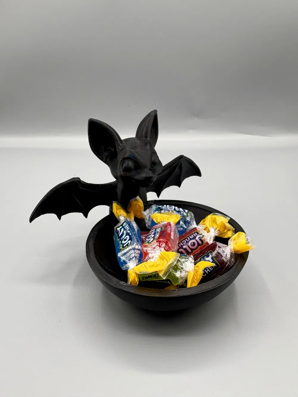 Perched Bat Halloween Treat Bowl — example colour. Includes: One finished item supplied; display accessories are excluded. Approximate dimensions (Width × Depth × Height): 1 supplied: 166.9 × 152 × 122.1 mm.