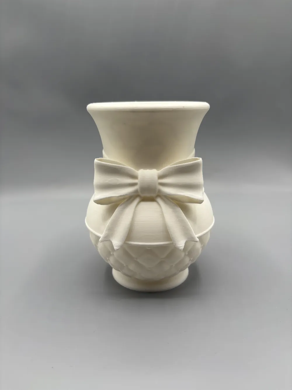 Quilted Spring Bow Decorative Vase — example colour. Includes: One finished item supplied; display accessories are excluded. Approximate dimensions (Width × Depth × Height): 1 supplied: 135.7 × 134.4 × 177.8 mm.