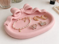 Bow Accent Oval Vanity Jewellery Tray — example colour. Includes: One finished item supplied; display accessories are excluded. Approximate dimensions (Width × Depth × Height): 1 supplied: 139.7 × 104.1 × 41.1 mm.