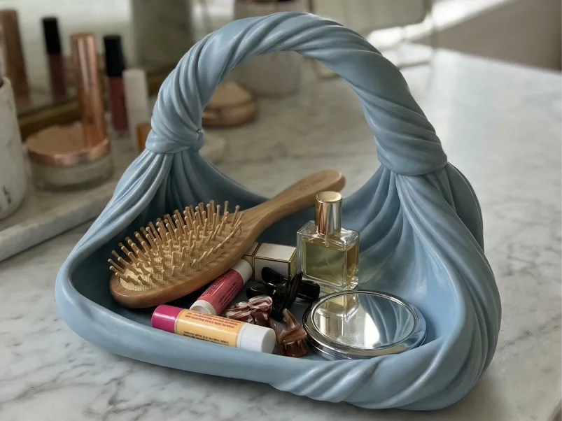 Twisted Handbag-Style Vanity Organiser — example colour. Includes: One finished item supplied; display accessories are excluded. Approximate dimensions (Width × Depth × Height): 1 supplied: 177.8 × 102.1 × 122.8 mm.