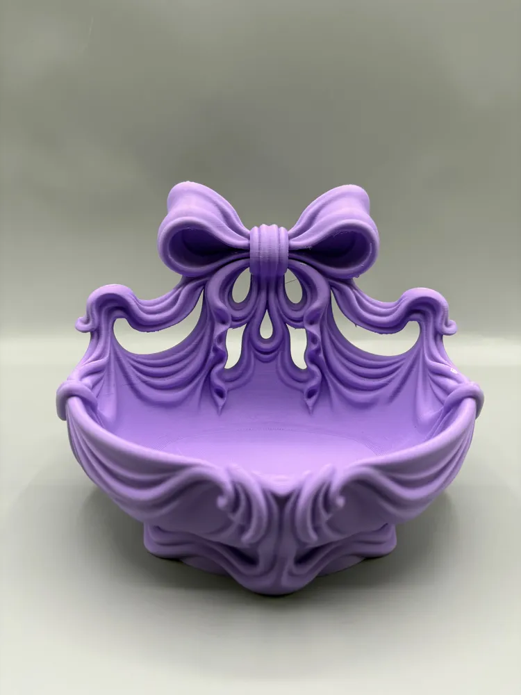 Flowing Ribbon Bow Catchall Basket — example colour. Includes: One finished item supplied; display accessories are excluded. Approximate dimensions (Width × Depth × Height): 1 supplied: 165.1 × 133.9 × 126.9 mm.