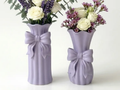 Ribbon Bow Decorative Vase Duo — example colour. Includes: Two printed decorative vases: one tall and one petite; flowers and display accessories excluded. Approximate dimensions (Width × Depth × Height): 1 supplied: 75.7 × 73.6 × 169.4 mm; 1 supplied: 78.7 × 76.5 × 154.9 mm.