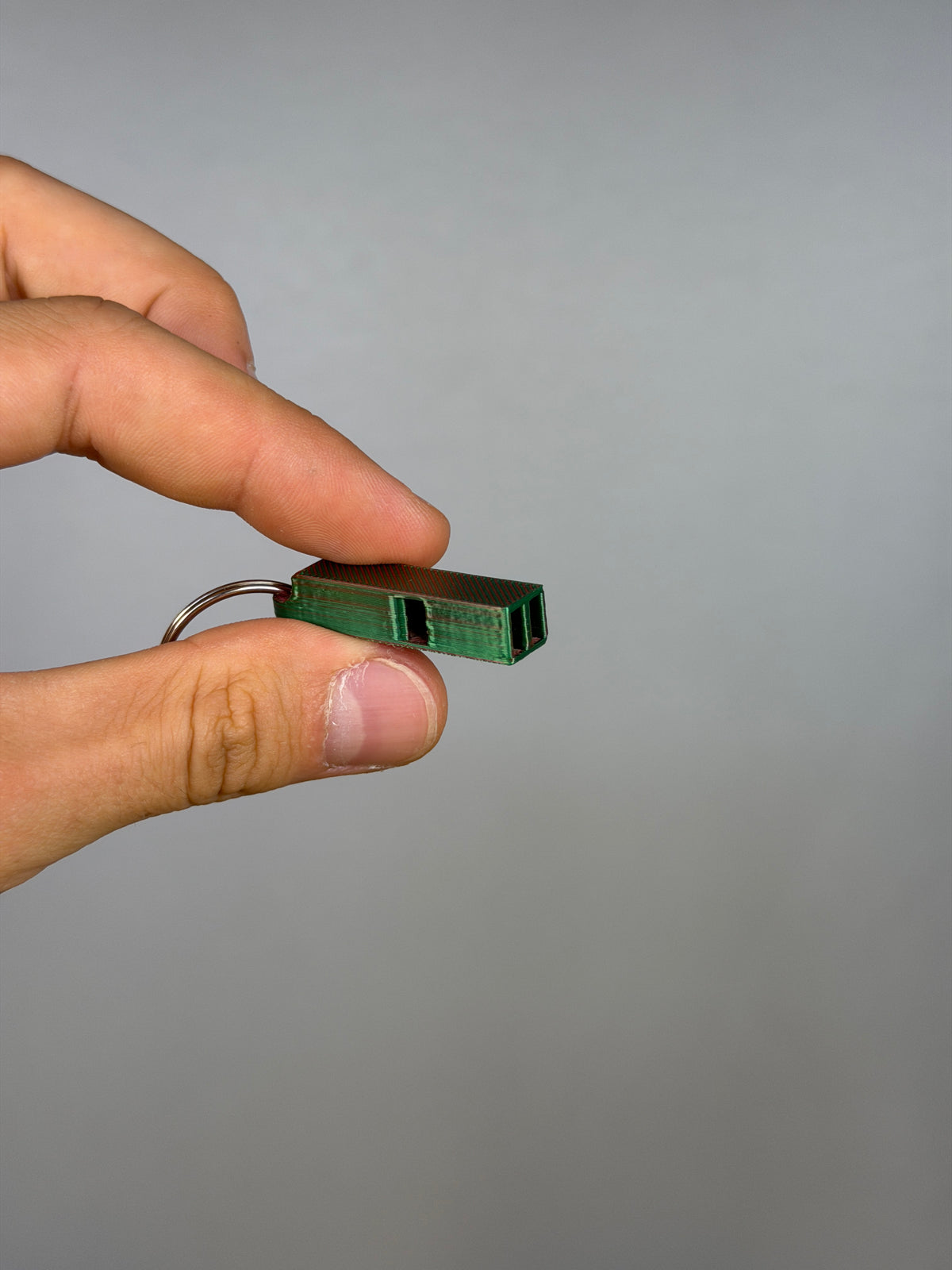 Mini Dual Chamber Whistle - Pack of 10 — example photo. Pack contains ten printed whistles; pictured accessories are not included.