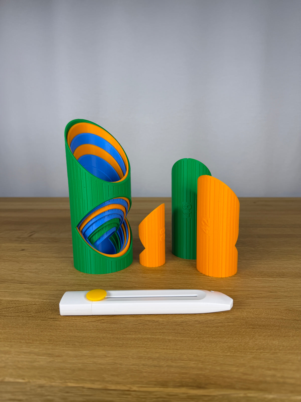 Example pipe insulation cutting guides in assorted colours with a knife