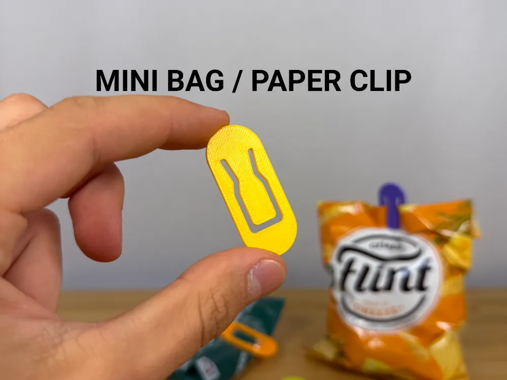 Mini Bag / Paper Clip — example colour. Includes: one mini bag / paper clip. Approximate dimensions (Width × Depth × Height): 1 supplied: 46.4 × 20 × 1.8 mm.