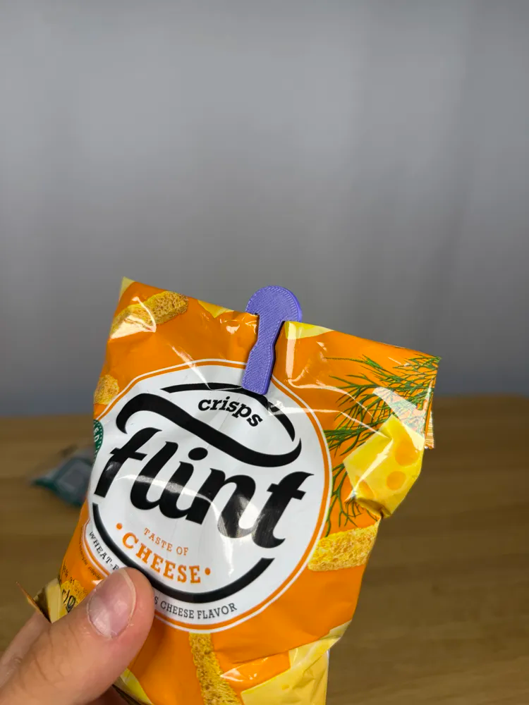 Mini Bag / Paper Clip — example colour. Includes: one mini bag / paper clip. Approximate dimensions (Width × Depth × Height): 1 supplied: 46.4 × 20 × 1.8 mm.