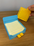 Sticky Note / Post-it Holder with Stencils — example colour. Includes: One complete printed item in the selected configuration. Approximate dimensions (Width × Depth × Height): 1 supplied: 83.4 × 83.3 × 65.5 mm; 3 supplied: 76 × 90 × 1.6 mm.