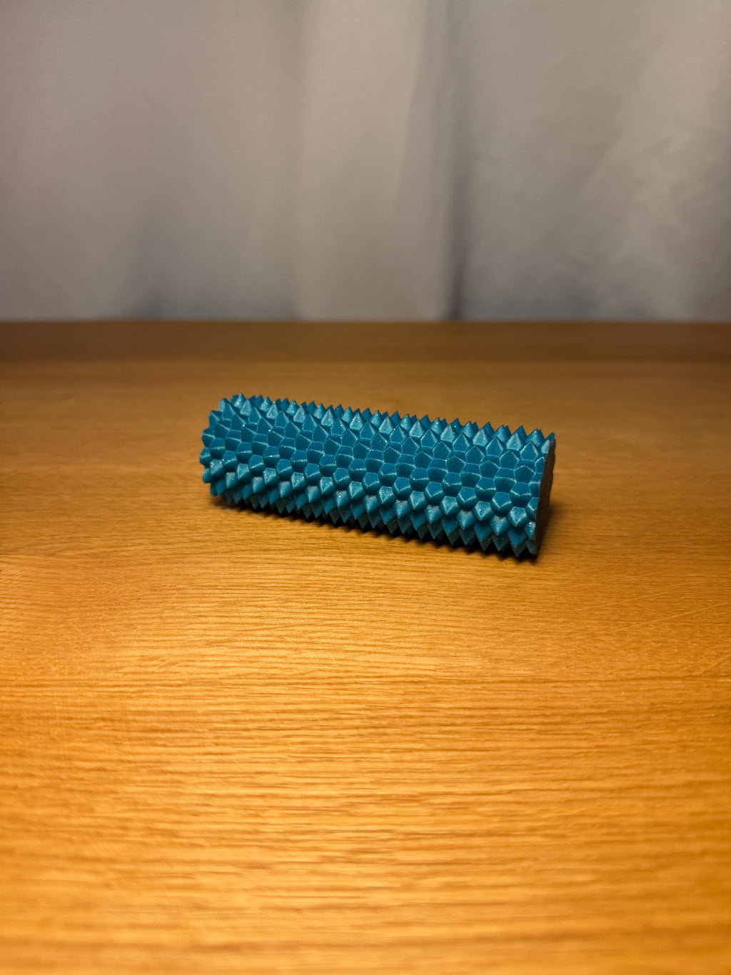 Spiky sensory fidget roller in an example colour.