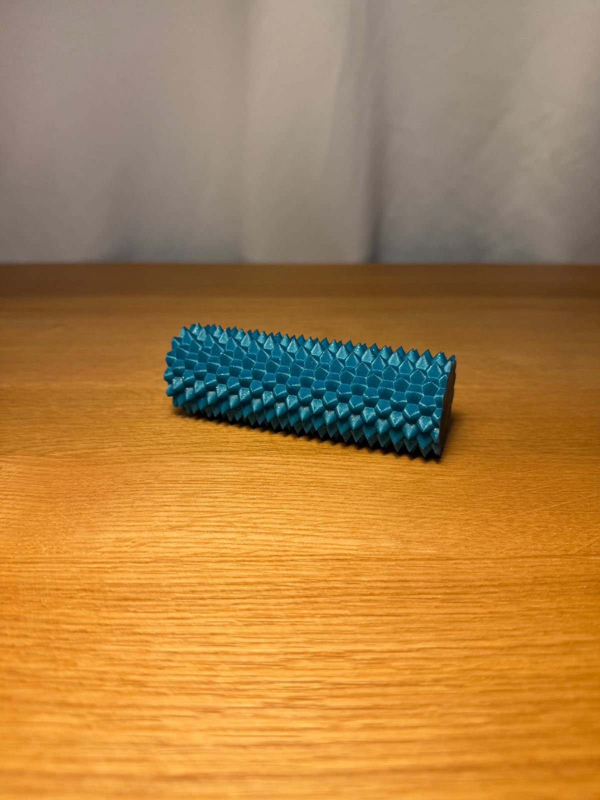 Spiky sensory fidget roller in an example colour.