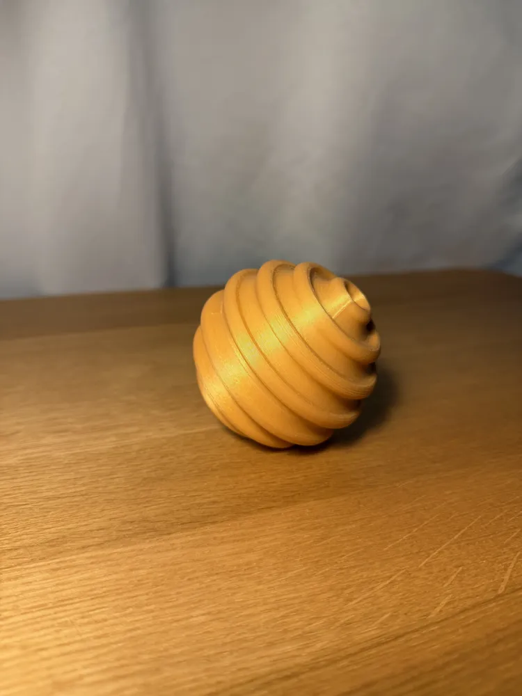 Sensory Fidget Sphere - Ribbed — example colour. Includes: one sensory fidget sphere - ribbed. Approximate dimensions (W × D × H): • Ribbed sphere halves (each): 80 × 79.8 × 40 mm. • Connector peg: 45.2 × 45.2 × 35.8 mm.