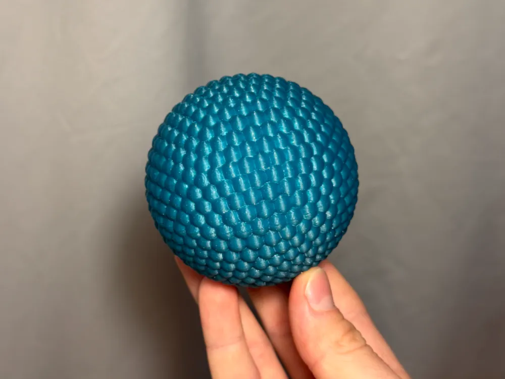 Sensory Fidget Sphere - Rounded — example colour. Includes: one sensory fidget sphere - rounded. Approximate dimensions (W × D × H): • Rounded sphere half A: 79.9 × 79.9 × 40 mm. • Rounded sphere half B: 80 × 80 × 40 mm. • Connector peg: 34.6 × 34.6 × 28.6 mm.