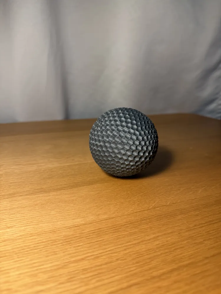 Sensory Fidget Sphere - Dimpled — example colour. Includes: one sensory fidget sphere - dimpled. Approximate dimensions (W × D × H): • Dimpled sphere half A: 81 × 80.8 × 40 mm. • Dimpled sphere half B: 81 × 80.8 × 40 mm. • Connector peg: 34.6 × 34.6 × 28.6 mm.