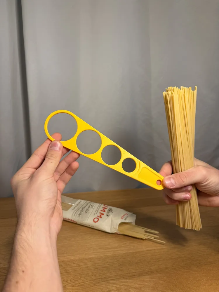 Spaghetti Measure — example colour. Includes: one spaghetti measure. Approximate dimensions (W × D × H): • Spaghetti Measure: 230.4 × 58.8 × 7 mm.