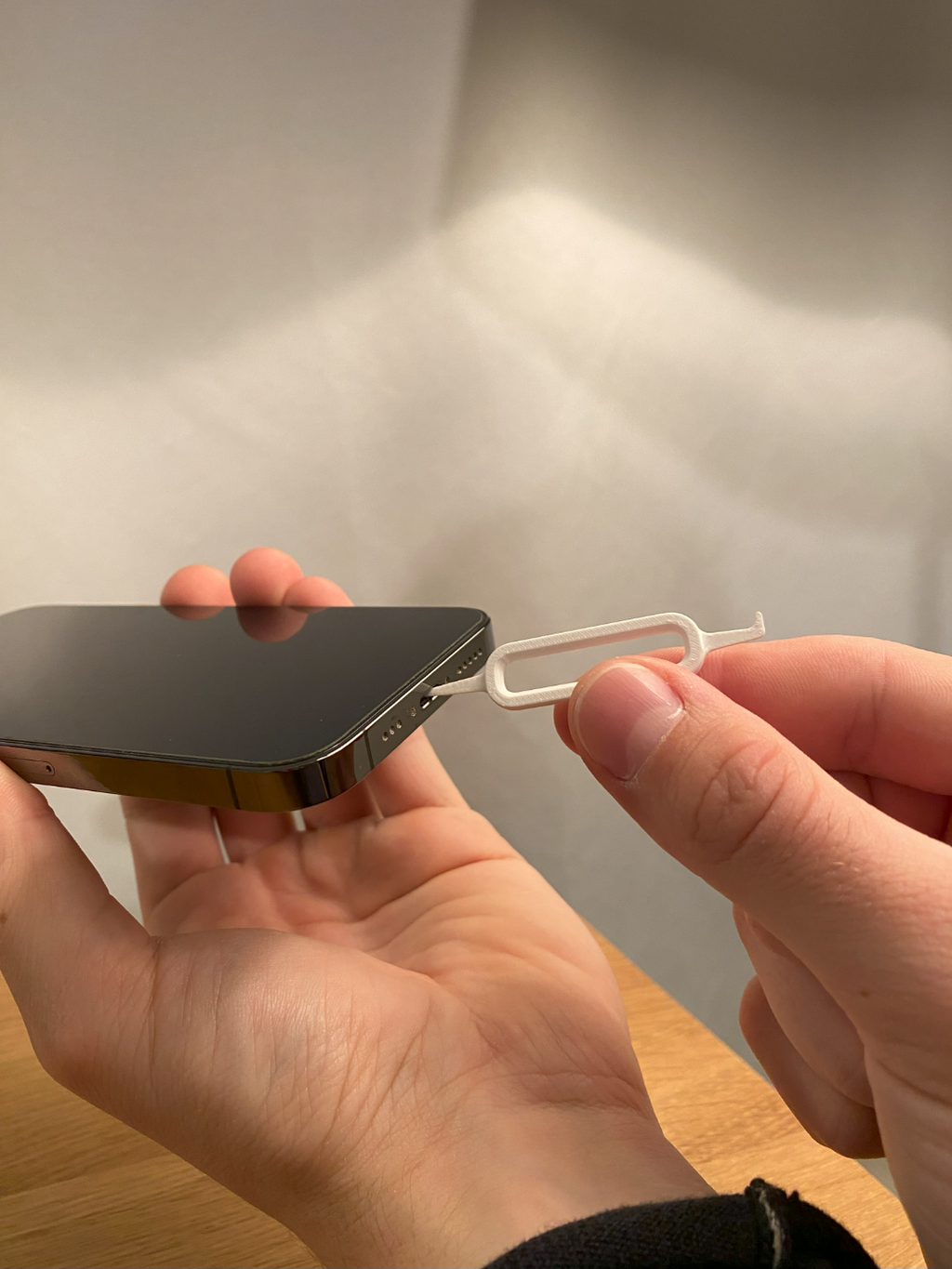 Printed charger port tool shown with an example phone