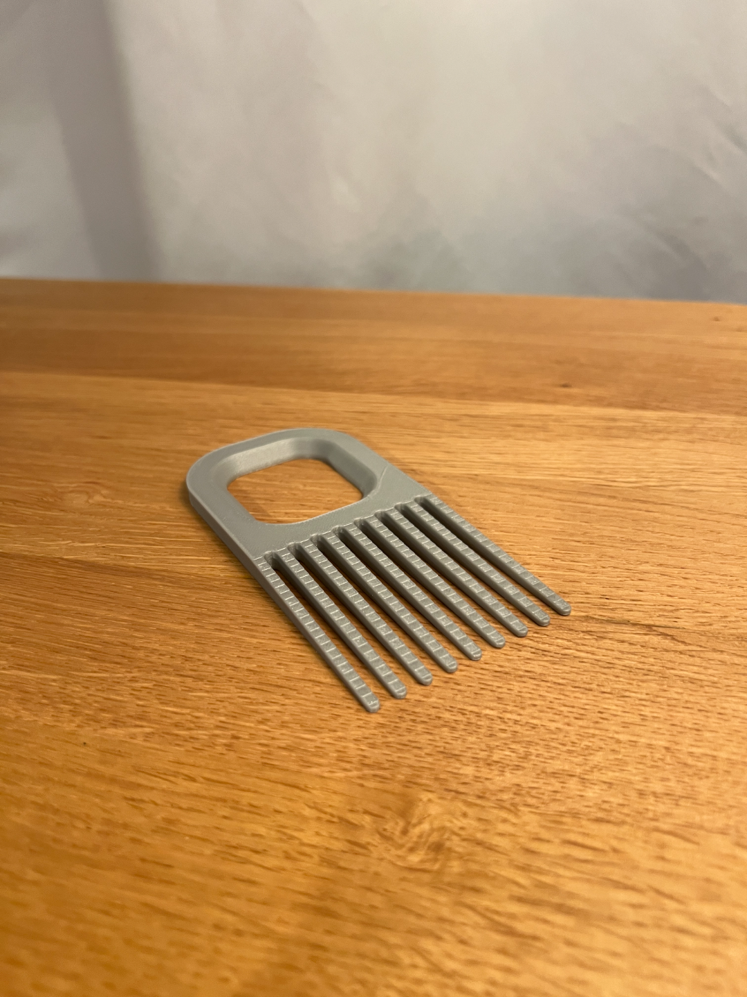 Wide printed hairbrush cleaner on a table