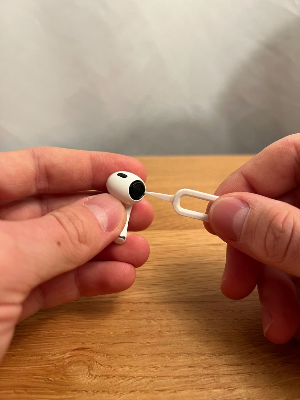 Printed earbud cleaning tool shown with an example earbud