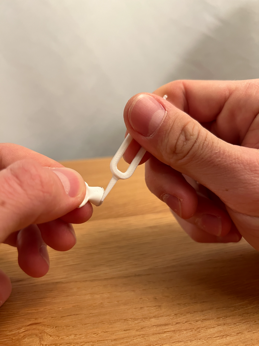 Printed earbud cleaning tool shown beside an example earbud