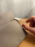 White 3D-printed letter opener shown opening an envelope