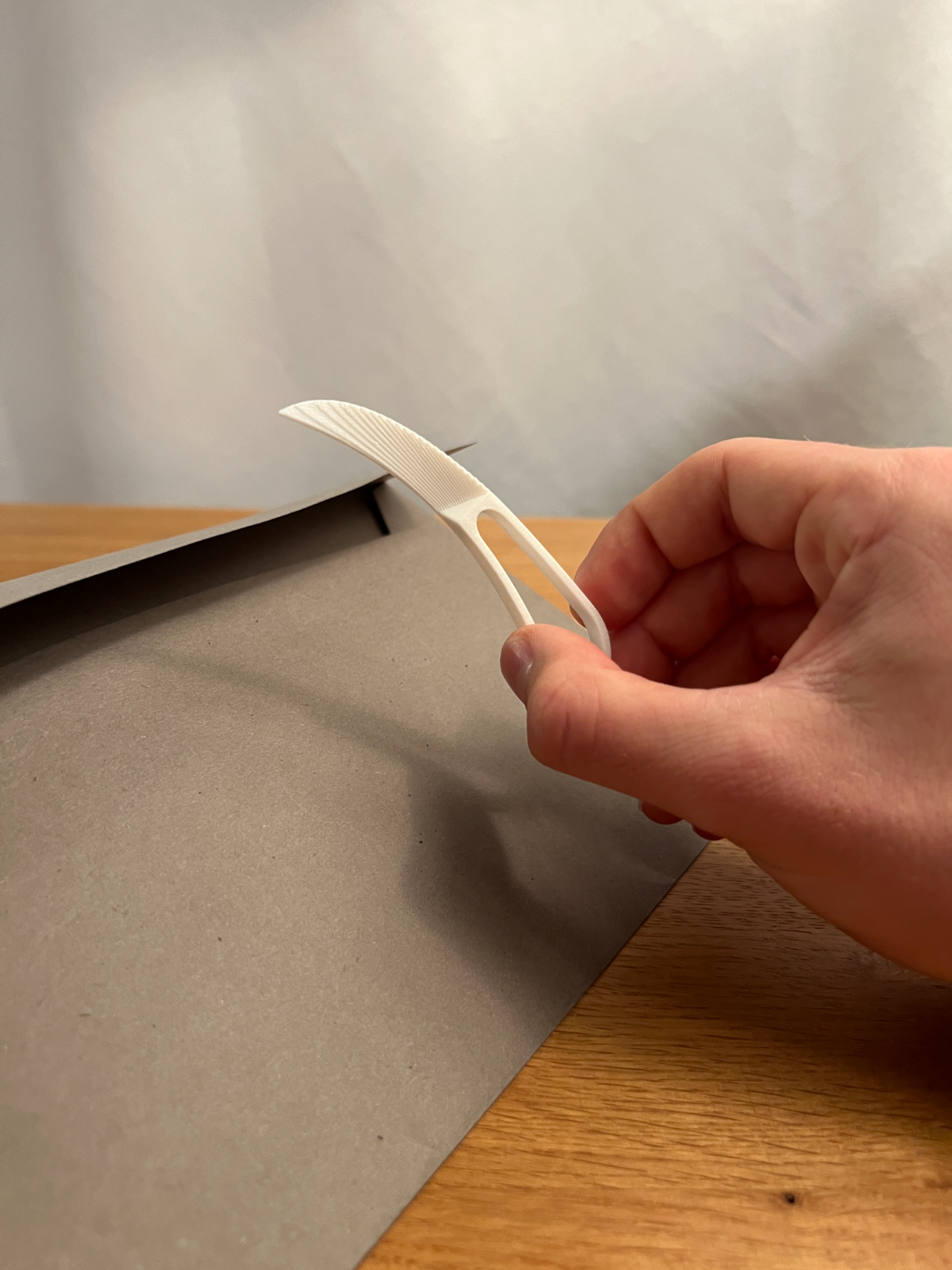 White 3D-printed letter opener beside an envelope
