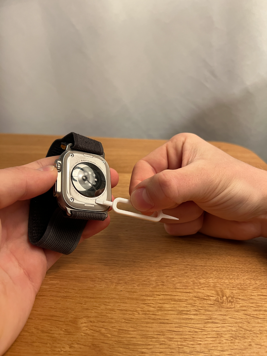 Printed watch cleaning tool shown beside an example watch