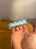 Printed mini grocery bag handle held in a hand